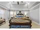 Bright main bedroom with a king-size bed and a ceiling fan at 7112 Hasentree Way, Wake Forest, NC 27587