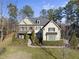 Two-story house with stone and shingle accents, landscaping, and a welcoming front porch at 7112 Hasentree Way, Wake Forest, NC 27587