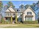 Two-story house with stone and shingle accents, landscaping, and a welcoming front porch at 7112 Hasentree Way, Wake Forest, NC 27587