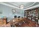 Home office with built-in bookcase and hardwood floors at 7112 Hasentree Way, Wake Forest, NC 27587