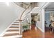Elegant curved staircase with wooden railing and hardwood floors at 7112 Hasentree Way, Wake Forest, NC 27587