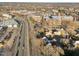 An aerial view of a community showcasing brick buildings, roadways, and residential homes at 8 Kingston Mill Ct, Durham, NC 27701