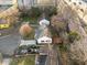 Aerial view showing the property, surrounded by mature trees and well maintained landscaping at 8 Kingston Mill Ct, Durham, NC 27701