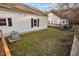 Backyard of white siding home with air conditioner and grassy area at 8 Kingston Mill Ct, Durham, NC 27701