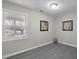 A bright bedroom featuring a large window, wood-look flooring, and modern wall art at 8 Kingston Mill Ct, Durham, NC 27701