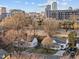 A cozy home exterior displaying mature trees and an urban setting with nearby buildings at 8 Kingston Mill Ct, Durham, NC 27701