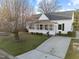 Classic home with a welcoming screened-in porch, complemented by a lush front lawn and private driveway at 8 Kingston Mill Ct, Durham, NC 27701