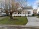 Charming white home featuring a delightful screened-in porch and a well-manicured front yard at 8 Kingston Mill Ct, Durham, NC 27701
