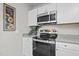 Bright kitchen featuring stainless steel appliances and ample cabinet space at 8 Kingston Mill Ct, Durham, NC 27701