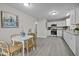 Open kitchen and dining area with stainless steel appliances and granite countertops at 8 Kingston Mill Ct, Durham, NC 27701