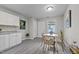 Eat-in kitchen features a window, small table and white cabinets at 8 Kingston Mill Ct, Durham, NC 27701
