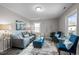 A cozy living room with modern furniture, a patterned rug, and a bright window at 8 Kingston Mill Ct, Durham, NC 27701