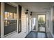 Enclosed front porch of home featuring ample windows and a screen door at 8 Kingston Mill Ct, Durham, NC 27701