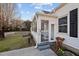 Exterior view of enclosed porch with white trim and windows on a sunny day at 8 Kingston Mill Ct, Durham, NC 27701