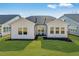 Backyard featuring a well-maintained lawn and the rear of the home at 804 Heathered Farm Way, Apex, NC 27523