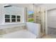 Bright bathroom with a soaking tub and separate glass shower at 804 Heathered Farm Way, Apex, NC 27523