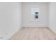 Neutral bedroom featuring light wood floors and a window for natural light at 804 Heathered Farm Way, Apex, NC 27523