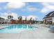 Community pool with a splash pad, lounge chairs, and additional covered seating areas at 804 Heathered Farm Way, Apex, NC 27523