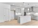 Spacious kitchen featuring stainless steel appliances, an island, and gray cabinetry at 804 Heathered Farm Way, Apex, NC 27523