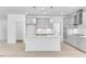 Contemporary kitchen with white island, modern appliances, and pendant lighting at 804 Heathered Farm Way, Apex, NC 27523