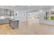 Modern kitchen with an island bar and gray cabinets and stainless steel appliances at 804 Heathered Farm Way, Apex, NC 27523