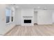 Bright living room with a modern fireplace and sleek hardwood flooring throughout at 804 Heathered Farm Way, Apex, NC 27523