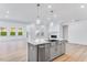 Open-concept living room with hardwood floors and abundant natural light from large windows at 804 Heathered Farm Way, Apex, NC 27523