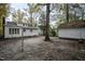 Spacious backyard with mature trees and detached white storage shed at 925 Redgate Ave, Rocky Mount, NC 27801