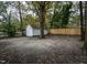 Spacious backyard with mature trees and detached white storage shed at 925 Redgate Ave, Rocky Mount, NC 27801