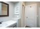 Bathroom with vanity, built-in shelving, framed mirror, and closet at 925 Redgate Ave, Rocky Mount, NC 27801