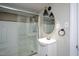 Bathroom features a single sink vanity, oval mirror, and shower with glass doors at 925 Redgate Ave, Rocky Mount, NC 27801