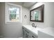 Bathroom featuring gray vanity with a large framed mirror and natural lighting at 925 Redgate Ave, Rocky Mount, NC 27801