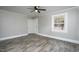Bedroom featuring wood-look floors, fresh paint, ceiling fan, and a bright window at 925 Redgate Ave, Rocky Mount, NC 27801