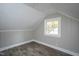 Attic bedroom featuring wood-look flooring and paneled walls at 925 Redgate Ave, Rocky Mount, NC 27801