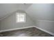 Attic bedroom featuring wood-look flooring and paneled walls at 925 Redgate Ave, Rocky Mount, NC 27801