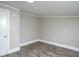 Bedroom showcasing wood-look flooring and paneled walls at 925 Redgate Ave, Rocky Mount, NC 27801