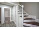Hallway featuring hardwood stairs with white banisters and doors to adjacent rooms at 925 Redgate Ave, Rocky Mount, NC 27801
