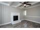 Living room featuring a white-painted brick fireplace and wood-look flooring at 925 Redgate Ave, Rocky Mount, NC 27801