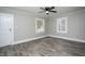 Spacious living room with wood-look floors, ceiling fan, and ample natural light at 925 Redgate Ave, Rocky Mount, NC 27801