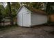 Exterior view of detached white storage shed with mature trees at 925 Redgate Ave, Rocky Mount, NC 27801