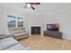 Living room with hardwood floors, fireplace, and a large TV at 10 Courtland Dr, Centerville, NC 27549