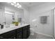 Double vanity bathroom with dark wood cabinets and a shower at 104 Ridgeline Ct, Durham, NC 27703