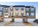 Attractive townhomes with diverse siding, complementary shutters and brick bases provide visual interest at 104 Ridgeline Ct, Durham, NC 27703