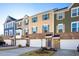 Charming townhomes with colorful facades, brick accents, and attached garages create curb appeal at 104 Ridgeline Ct, Durham, NC 27703