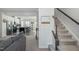 Modern kitchen with island and stainless steel appliances, visible from a staircase at 104 Ridgeline Ct, Durham, NC 27703