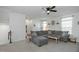 Living room with L-shaped sectional sofa and ceiling fan at 104 Ridgeline Ct, Durham, NC 27703