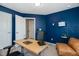 Home office with a standing desk, chair, and blue walls at 104 Ridgeline Ct, Durham, NC 27703