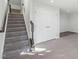 Gray carpeted staircase with dark wood railing at 104 Ridgeline Ct, Durham, NC 27703
