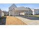 Covered carport with concrete driveway and adjacent grassy yard at 107 York Dr, Oxford, NC 27565