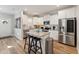Modern kitchen with white cabinets, granite island, stainless steel appliances at 107 York Dr, Oxford, NC 27565
